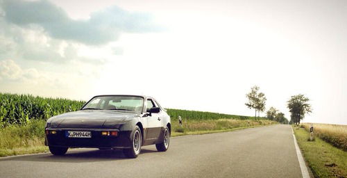 Porsche 944 driving along a road